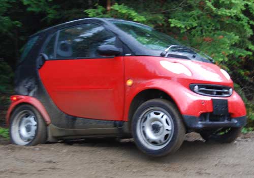 Smart Car stuck in the gravel and on three wheels