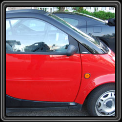 Englsh Bulldog Poke-A-Roo rides in the smart car